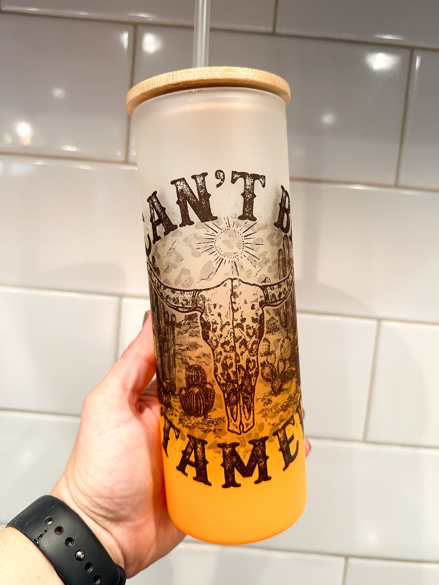 Can't Be Tamed | Western | 25 oz Glass Tumbler with Bamboo Lid | Frosted Orange Glass | Iced Coffee Lover