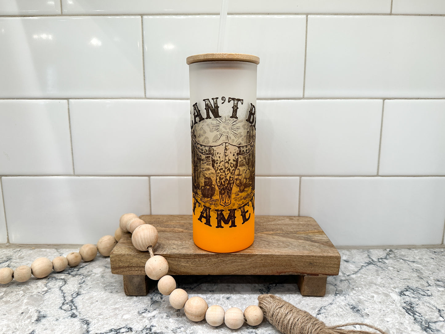 Can't Be Tamed | Western | 25 oz Glass Tumbler with Bamboo Lid | Frosted Orange Glass | Iced Coffee Lover