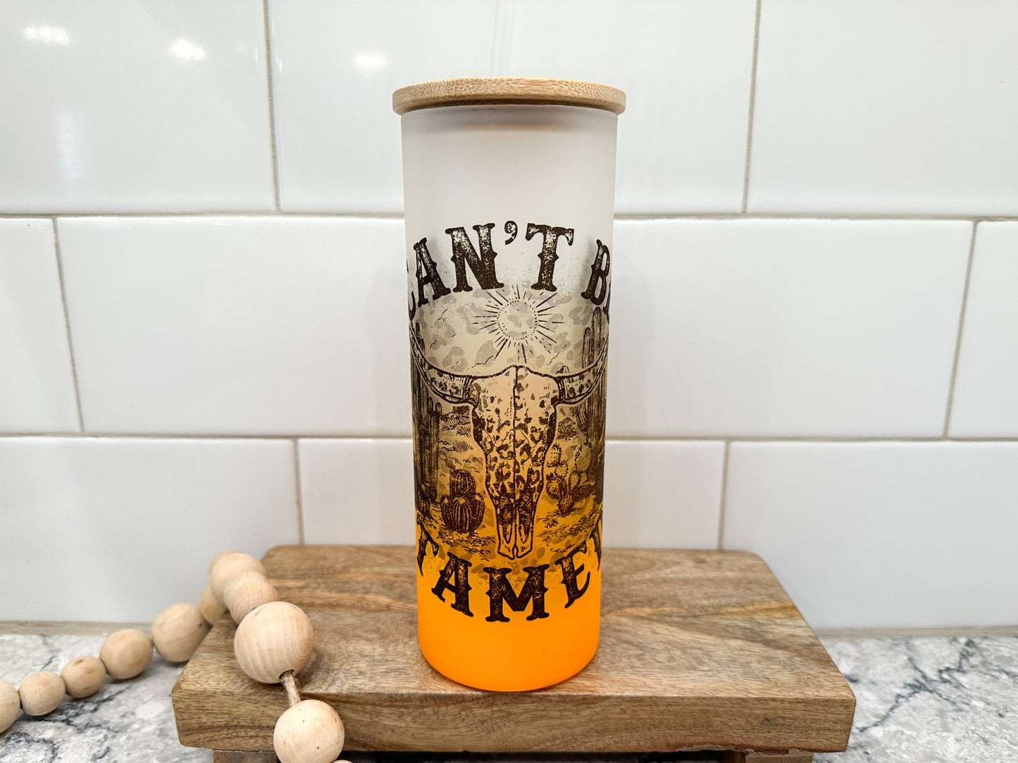 Can't Be Tamed | Western | 25 oz Glass Tumbler with Bamboo Lid | Frosted Orange Glass | Iced Coffee Lover